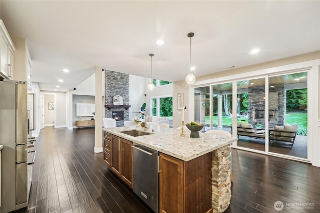 24130 145th Ave SE, Snohomish, WA 98296 - kitchen with a stone fireplace, stainless steel appliances, dark wood finished floors, and recessed lighting