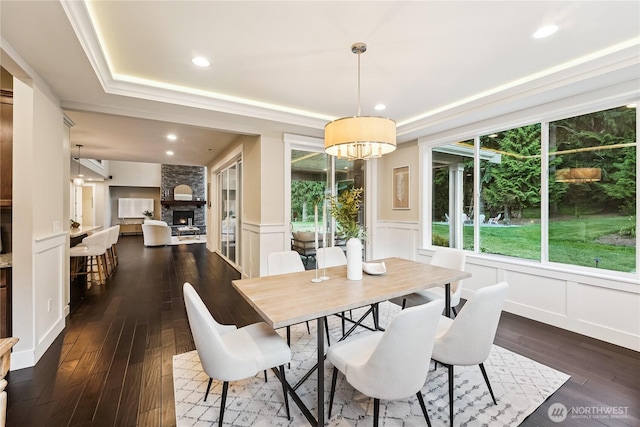 24130 145th Ave SE, Snohomish, WA 98296 - dining space featuring a decorative wall, dark wood-style floors, a raised ceiling, recessed lighting, and a wainscoted wall