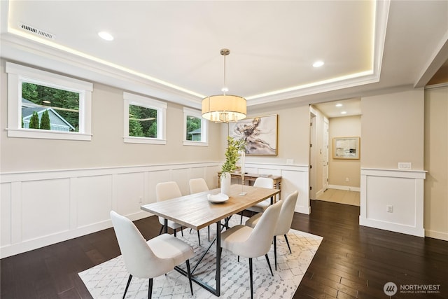 24130 145th Ave SE, Snohomish, WA 98296 - dining area with a raised ceiling, dark wood-style flooring, a chandelier, a decorative wall, and wainscoting