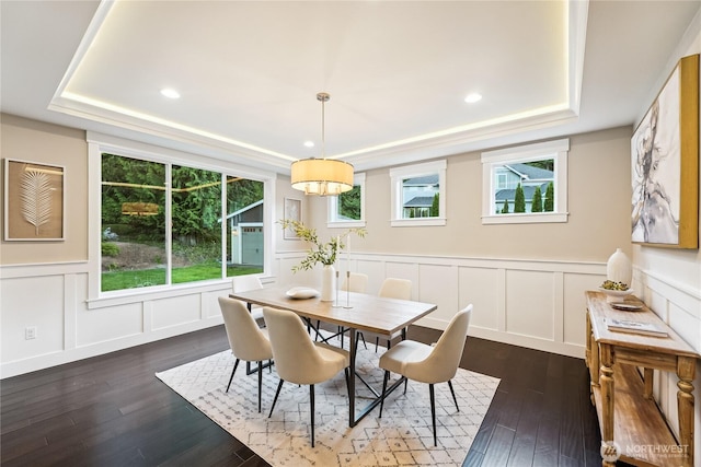 24130 145th Ave SE, Snohomish, WA 98296 - dining space featuring a tray ceiling, a decorative wall, dark wood-type flooring, recessed lighting, and a wainscoted wall