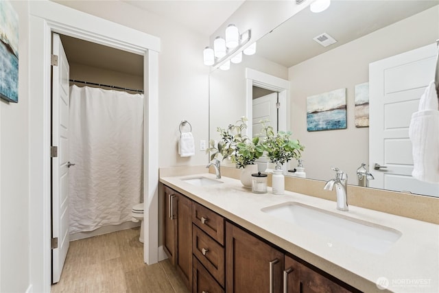 24130 145th Ave SE, Snohomish, WA 98296 - full bathroom with double vanity, wood finished floors, and a shower with shower curtain
