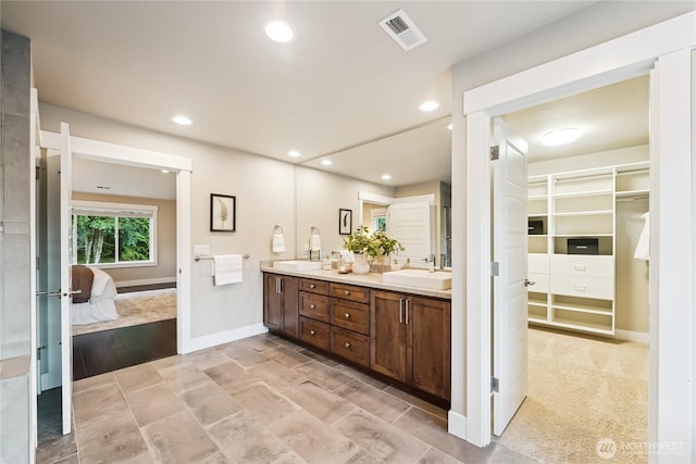 24130 145th Ave SE, Snohomish, WA 98296 - ensuite bathroom featuring double vanity, a spacious closet, and recessed lighting