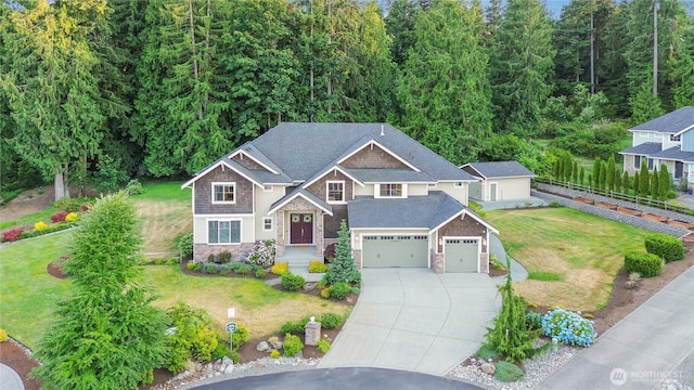 24130 145th Ave SE, Snohomish, WA 98296 - view of front of home featuring stone siding, concrete driveway, a front yard, and a garage