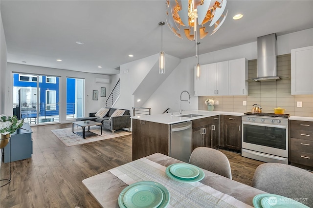 8537 22nd Pl NE, Seattle, WA 98115 - kitchen with stainless steel appliances, wall chimney range hood, dark brown cabinetry, open floor plan, and white cabinets
