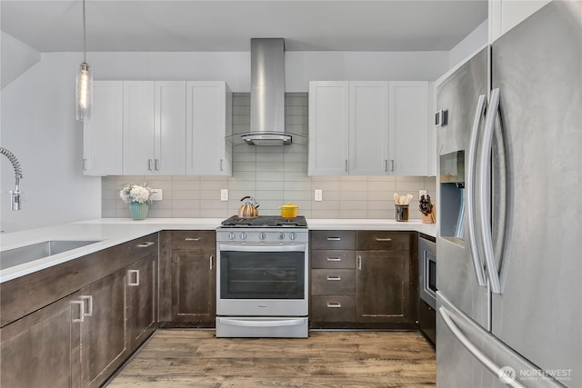 8537 22nd Pl NE, Seattle, WA 98115 - kitchen with appliances with stainless steel finishes, wall chimney exhaust hood, white cabinetry, and dark brown cabinets