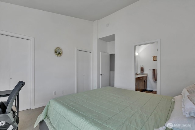 8537 22nd Pl NE, Seattle, WA 98115 - bedroom featuring multiple closets, a towering ceiling, and carpet flooring