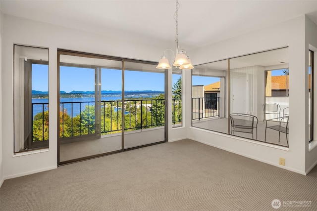 8005 Sand Point Way NE Unit A52, Seattle, WA 98115 - spare room featuring carpet, a chandelier, and a water view