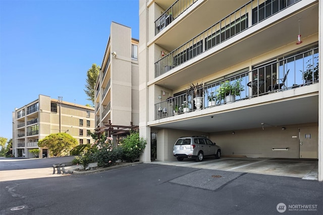 8005 Sand Point Way NE Unit A52, Seattle, WA 98115 - view of apartment building / complex with covered parking