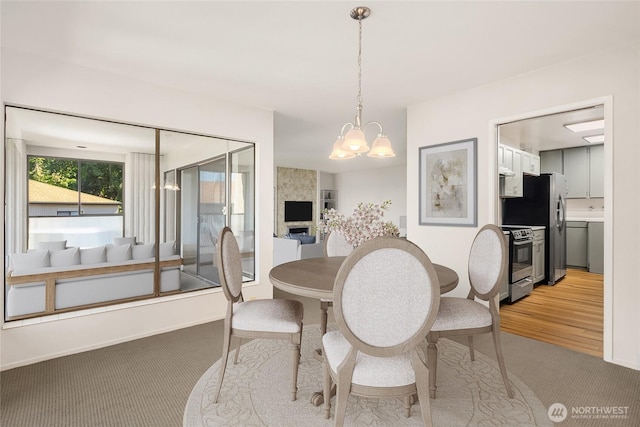 8005 Sand Point Way NE Unit A52, Seattle, WA 98115 - dining space with a chandelier and light colored carpet