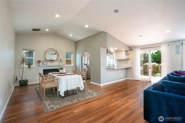 1717 SW 347th Pl, Federal Way, WA 98023 - dining space featuring vaulted ceiling, dark wood-style floors, a fireplace, and recessed lighting
