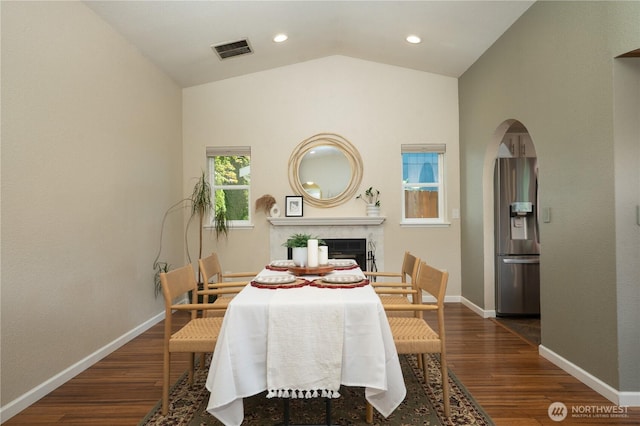 1717 SW 347th Pl, Federal Way, WA 98023 - dining space featuring lofted ceiling, wood finished floors, a premium fireplace, arched walkways, and recessed lighting