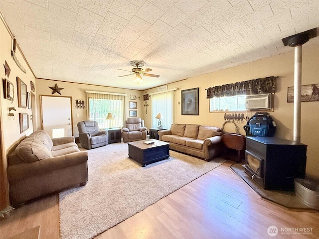 15 S Heise Rd, Elma, WA 98541 - living room with a wood stove, wood finished floors, and a ceiling fan
