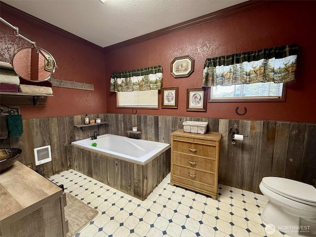 15 S Heise Rd, Elma, WA 98541 - full bath with tile patterned floors, wainscoting, crown molding, a garden tub, and a textured ceiling