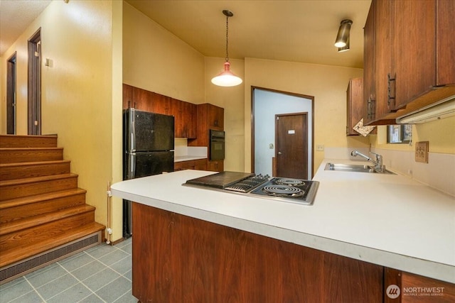 18707 25th Ave NE, Lake Forest Park, WA 98155 - kitchen with black appliances, a peninsula, light countertops, pendant lighting, and brown cabinetry