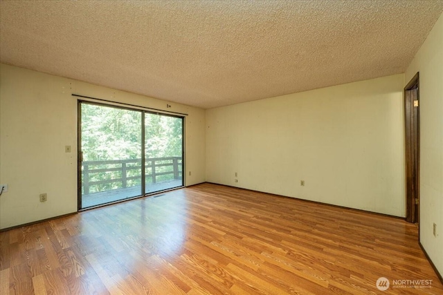 18707 25th Ave NE, Lake Forest Park, WA 98155 - unfurnished room with light wood-type flooring and a textured ceiling