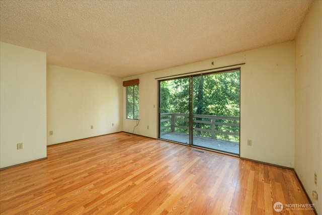 18707 25th Ave NE, Lake Forest Park, WA 98155 - spare room featuring wood finished floors and a textured ceiling
