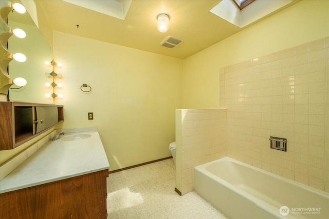 18707 25th Ave NE, Lake Forest Park, WA 98155 - bathroom featuring a skylight, a tub, and vanity