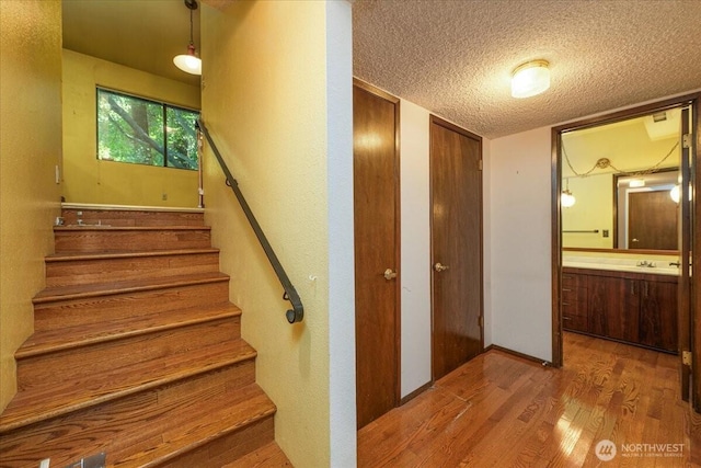 18707 25th Ave NE, Lake Forest Park, WA 98155 - stairs featuring wood finished floors and a textured ceiling