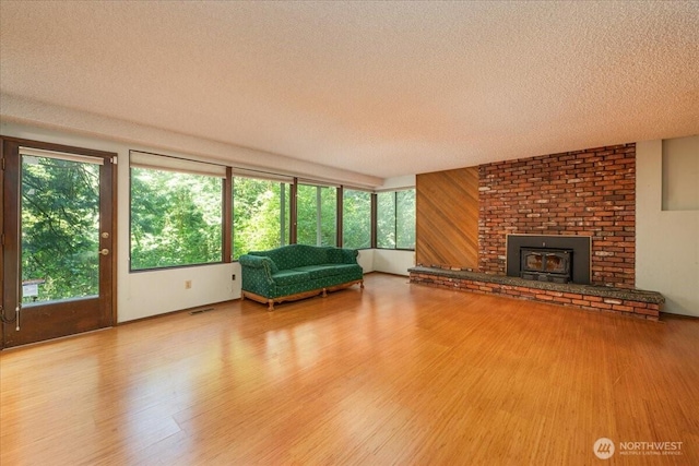 18707 25th Ave NE, Lake Forest Park, WA 98155 - living area with a textured ceiling, wood finished floors, and a brick fireplace