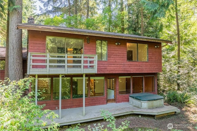 18707 25th Ave NE, Lake Forest Park, WA 98155 - back of house with a wooden deck, a chimney, and a sunroom