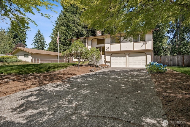 2810 Brentwood Dr SE, Lacey, WA 98503 - split foyer home featuring asphalt driveway, an attached garage, and stucco siding