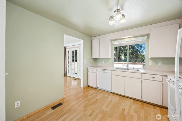 2810 Brentwood Dr SE, Lacey, WA 98503 - kitchen featuring white dishwasher, light wood-style flooring, light countertops, and white cabinetry