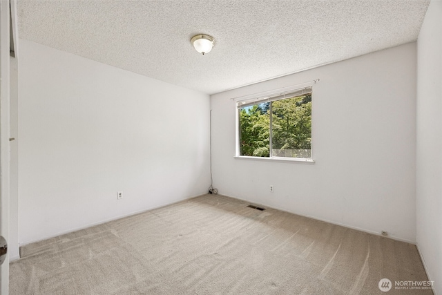 2810 Brentwood Dr SE, Lacey, WA 98503 - spare room featuring carpet flooring and a textured ceiling