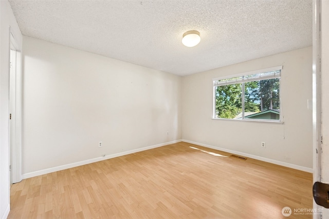 2810 Brentwood Dr SE, Lacey, WA 98503 - unfurnished bedroom featuring light wood finished floors and a textured ceiling