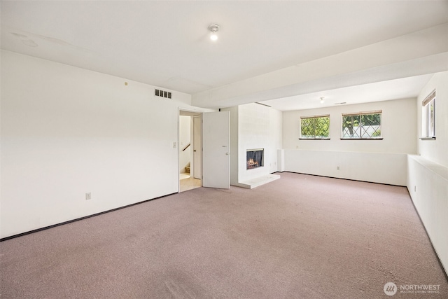 2810 Brentwood Dr SE, Lacey, WA 98503 - unfurnished living room with a large fireplace, carpet flooring, and stairs