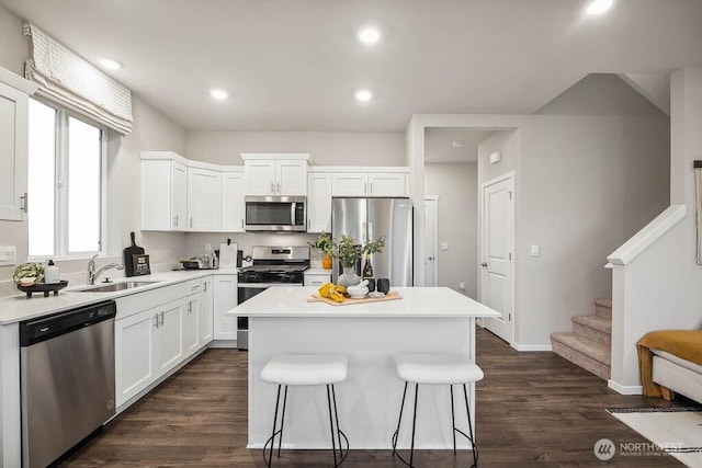 1713 Noble Ave Unit 76, Snohomish, WA 98290 - kitchen with stainless steel appliances, a center island, a breakfast bar, white cabinets, and recessed lighting