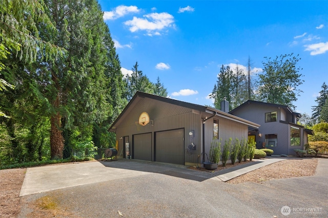 2515 87th Avenue Ct E, Edgewood, WA 98371 - view of front of house with a garage, driveway, and a chimney