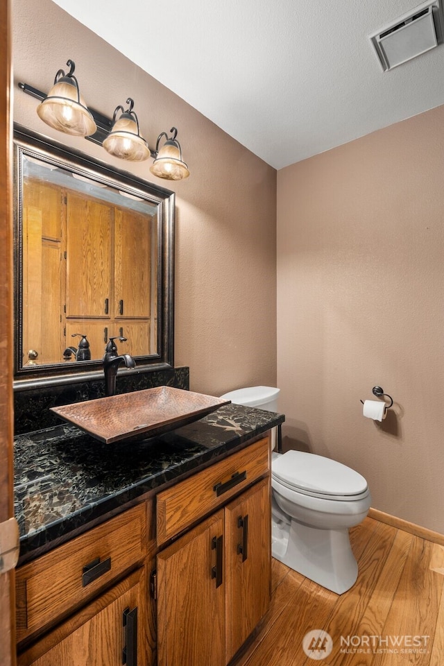 2515 87th Avenue Ct E, Edgewood, WA 98371 - half bathroom with vanity and wood finished floors