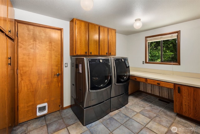 2515 87th Avenue Ct E, Edgewood, WA 98371 - washroom featuring independent washer and dryer, cabinet space, an office area, and a textured ceiling