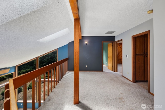 2515 87th Avenue Ct E, Edgewood, WA 98371 - corridor with a textured ceiling, a skylight, and carpet floors