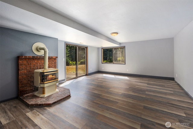 2515 87th Avenue Ct E, Edgewood, WA 98371 - unfurnished living room featuring a wood stove and wood finished floors