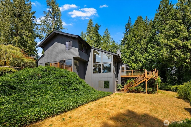 2515 87th Avenue Ct E, Edgewood, WA 98371 - rear view of house with stairs, a lawn, and a deck