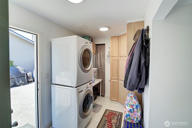 17003 53rd Ave S, Seatac, WA 98188 - laundry room featuring estacked washer and dryer, cabinet space, and light tile patterned floors