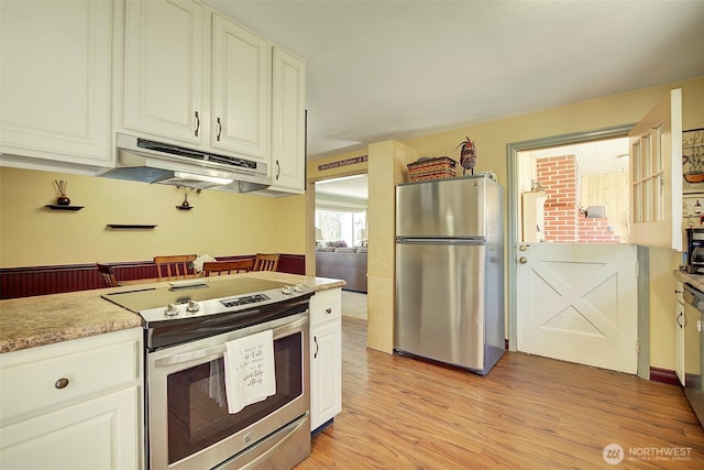 17003 53rd Ave S, Seatac, WA 98188 - kitchen featuring stainless steel appliances, under cabinet range hood, light wood-type flooring, and white cabinetry
