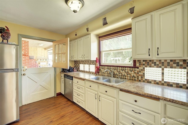17003 53rd Ave S, Seatac, WA 98188 - kitchen with appliances with stainless steel finishes, tasteful backsplash, light wood finished floors, and healthy amount of natural light