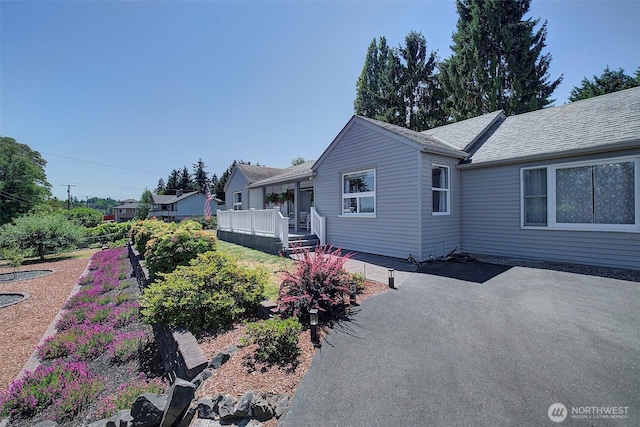 17003 53rd Ave S, Seatac, WA 98188 - view of side of property with a wooden deck and a shingled roof