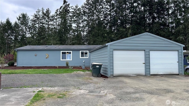 4805 Cushman Rd NE Unit 115, Olympia, WA 98506 - view of front of house featuring an outbuilding, a garage, and view of wooded area
