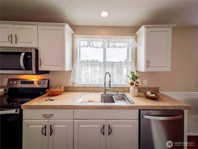 4805 Cushman Rd NE Unit 115, Olympia, WA 98506 - kitchen with appliances with stainless steel finishes, white cabinetry, and light countertops