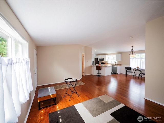 4805 Cushman Rd NE Unit 115, Olympia, WA 98506 - living area featuring dark wood-style flooring and baseboards