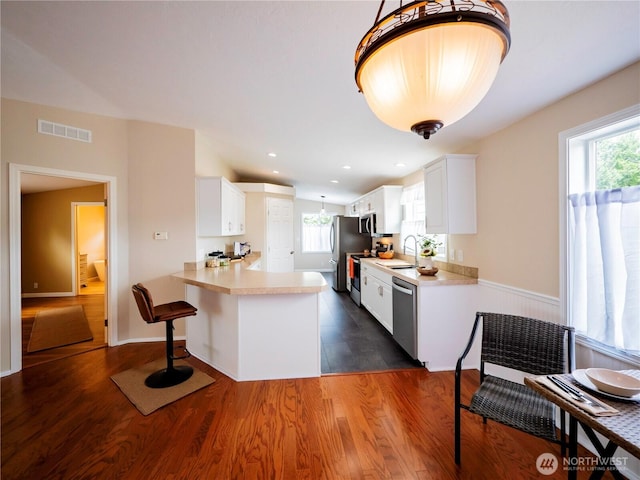 4805 Cushman Rd NE Unit 115, Olympia, WA 98506 - kitchen with light countertops, stainless steel appliances, dark wood finished floors, and white cabinetry