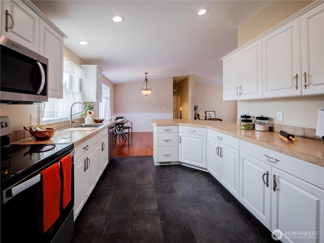 4805 Cushman Rd NE Unit 115, Olympia, WA 98506 - kitchen featuring appliances with stainless steel finishes, a peninsula, white cabinetry, light countertops, and recessed lighting