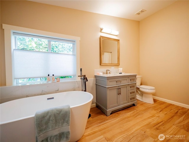 4805 Cushman Rd NE Unit 115, Olympia, WA 98506 - full bathroom with healthy amount of natural light, vanity, wood finished floors, and a freestanding bath