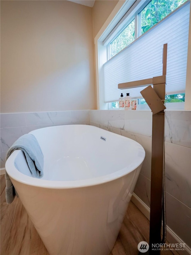 4805 Cushman Rd NE Unit 115, Olympia, WA 98506 - bathroom with tile walls, a freestanding tub, and wainscoting