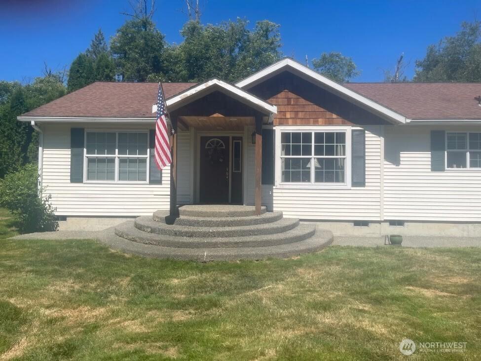 7203 Erna Ln, Sedro Woolley, WA 98284 - view of front of home featuring crawl space, a front yard, and a shingled roof