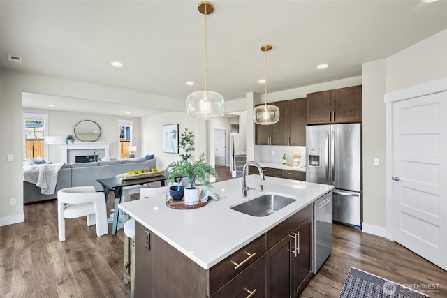 605 26th Avenue Ct, Milton, WA 98354 - kitchen featuring stainless steel appliances, dark brown cabinetry, light countertops, dark wood finished floors, and backsplash