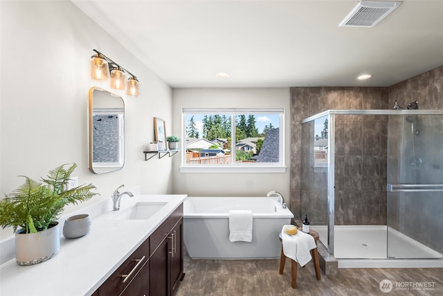 605 26th Avenue Ct, Milton, WA 98354 - bathroom with a freestanding bath, a stall shower, vanity, wood finished floors, and recessed lighting